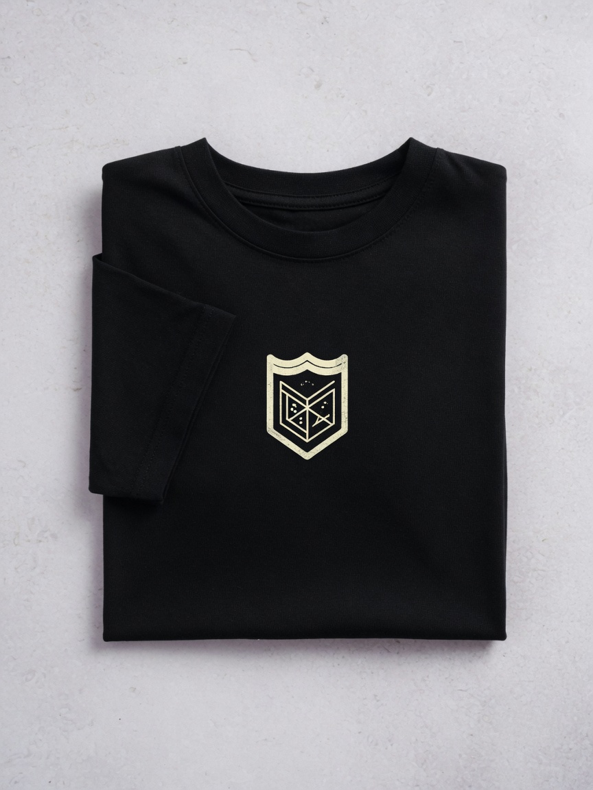 Folded black t-shirt with cream crest